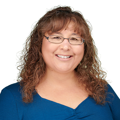 Professional headshot of a women against a blue background